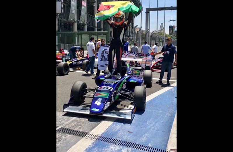 Calvin Ming stands atop his F4 car after taking race two