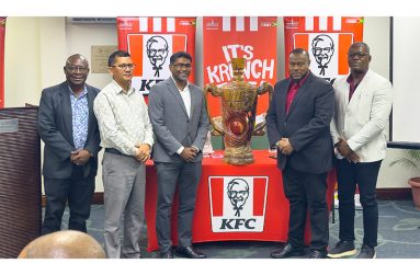 From left: Troy Peters (Petra Organisation), Deputy Chief Executive Officer Marti DeSouza, Paul Subryan (CEO of KFC Guyana), Troy Mendonca (Petra Organisation) and Franklin Wilson (Assistant Director of Sport) and the championship trophy at the launch on Wednesday evening (Japhet Savory Photo)