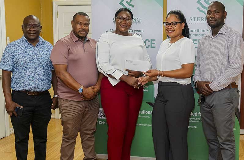 Sterling Products Limited Public Relations Manager Youlandra McCammon handed over the check to Petra secretary Jackie Boodie in the presence of other reps from Petra and Sterling