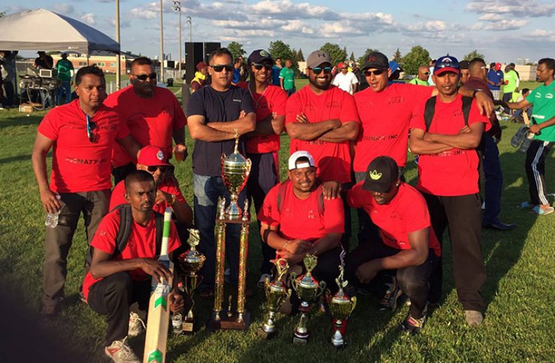 The victorious All Stars team pose with their winnings. Manager Pramchand Pitam Punwasi is at extreme left (standing).