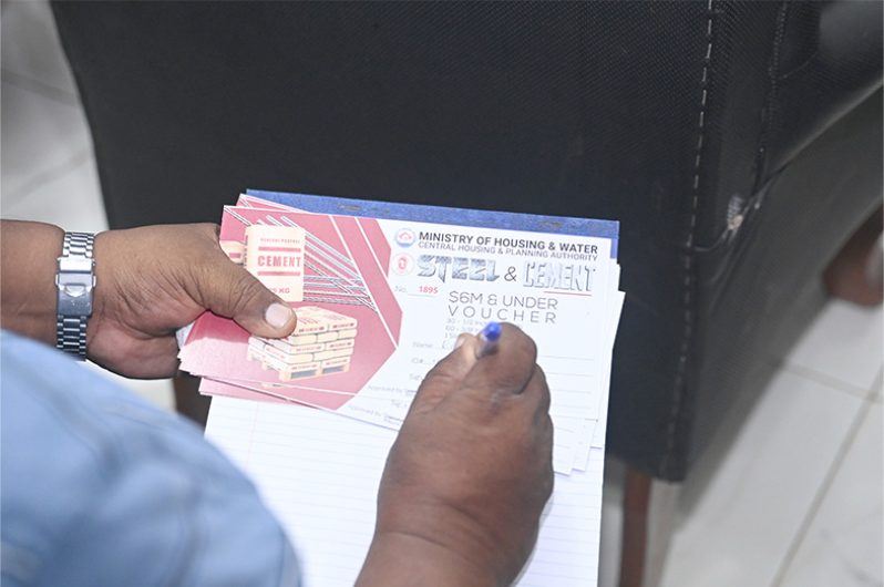 Regional Chairman, Brentnol Ashley provides one of the beneficiaries with a $300,000 voucher to purchase steel and cement. The vouchers must be redeemed within six months at Small’s Enterprise, a registered supplier