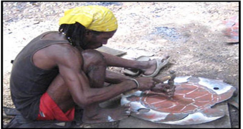 Hard at work, chiselling away on a steel drum