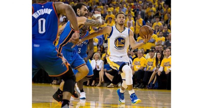Golden State Warriors guard Stephen Curry (30) dribbles the ball as Oklahoma City Thunder centre Steven Adams (12) defends during the second quarter in game five of the Western conference finals of the NBA Playoffs at Oracle Arena.
