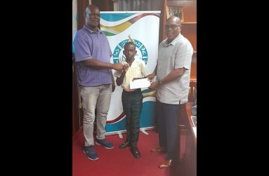 National Boxing Coach, Terrence Poole and national youth boxer, Keyon Britton (centre) alongside GBA president, Steve Ninvalle