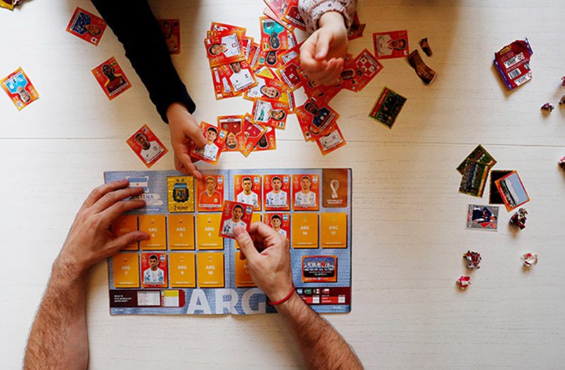 Lucas Perrone, 39, pastes World Cup stickers with his kids in Buenos Aires, Argentina