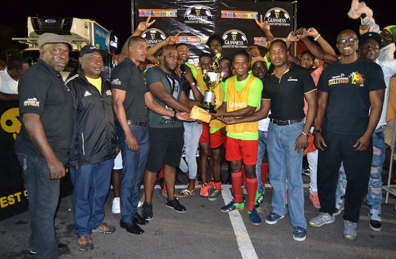 Flashback! The winning Showstoppers team pose with their cash and trophies following their 2-0 win over Hustlers in the final of the West Demerara Guinness Greatest in the Streets football competition. (Stephan Sookram photo)