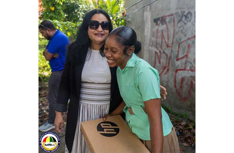 Minister of Human Services and Social Security, Dr. Vindhya Persaud and Reeanna shared a light moment after the latter was presented with a brand-new laptop, a gesture that left the young student visibly moved