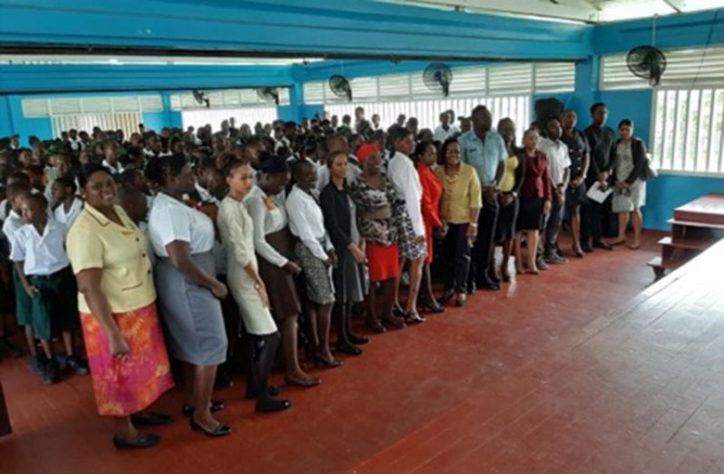Sergeant Kenyatta Bishop of Traffic Headquarters shares a moment with the South Ruimveldt Secondary School students who benefitted from the lecture