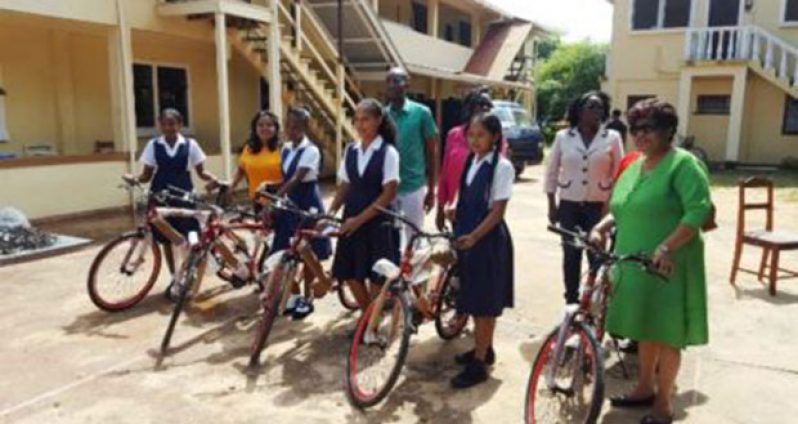 Minister of Social Cohesion Amna Ally and the top NGSA students of Region Nine with their bicycles