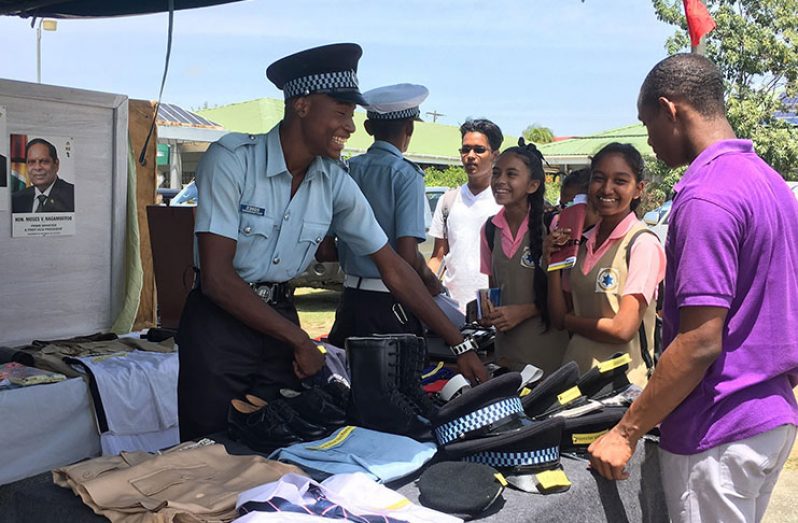 Students interact with officers of the Guyana Police Force at the Career Day fair