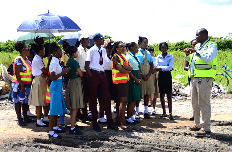 Landfill Site Manager Lloyd Stanton (extreme right), explaining the process to students