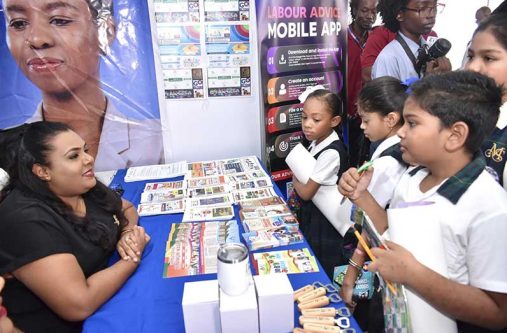 Students visited the Ministry of Labour and Manpower Planning booth at the opening of the Human Rights and Anti-Corruption Expo on Tuesday