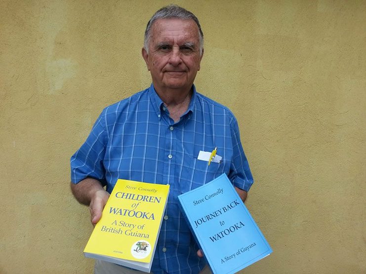 Mr. Steve Connolly holding the two books; Children of Watooka and Journey Back to Watooka