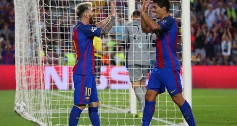 Barcelona's Luis Suarez celebrates scoring their seventh goal with Lionel Messi. (Reuters/Paul HannaLivepic)