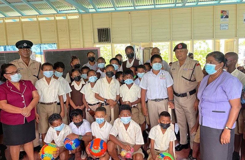 (Second from right) Deputy Commissioner 'Operations' (ag), Ravindradat Budhram with pupils and teachers of the Suddie Primary School