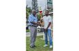 Jonhatan Sunich, son of Trophy Stall proprietor Ramesh Sunich, hands over one of the winning trophies to GSCL President Ian John.