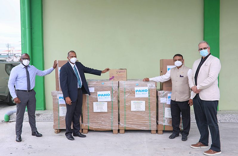 Minister of Health Dr. Frank Anthony and Permanent Secretary of the Ministry of Health, Malcolm Watkins (second and first left respectively), receive the items from High Commissioner of India to Guyana, Dr. K.J. Srinivasa and Resident PAHO/WHO Representative, Dr. Luis Felipe Codina (DPI photo)