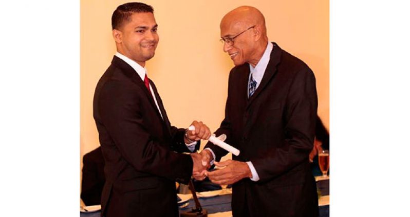 Dr Amarnauth Dukhi receives his certificate from Head of Neurosurgery in Cuba, Professor  Esteban Roig