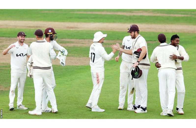 Surrey players celebrated on the pitch in Southampton as news of their title win filtered through,