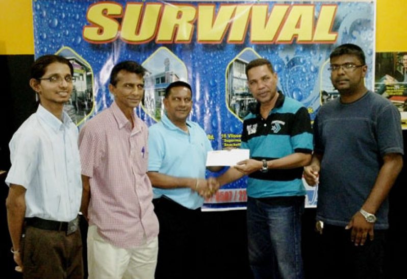 Assistant Manager of Survival Travel Agency, Mark DeFreitas, (second right), presents the tickets to Rohan Bhoj-Raj of the GFSCA in the presence of other representatives of the two bodies.