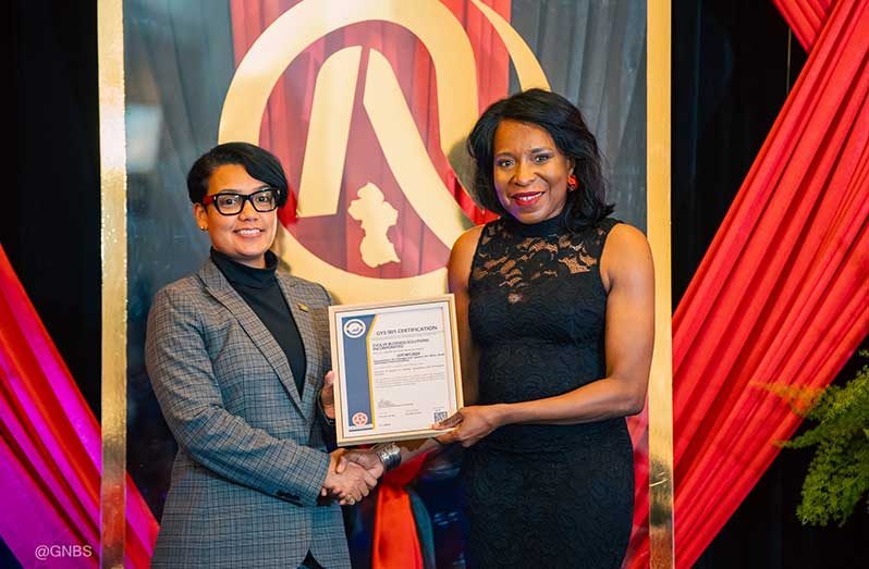 Minister of Tourism, Industry and Commerce, the Honourable Susan Rodrigues, presents the GYS 901 certificate to Avia Maria Lindie at NQA 2025
