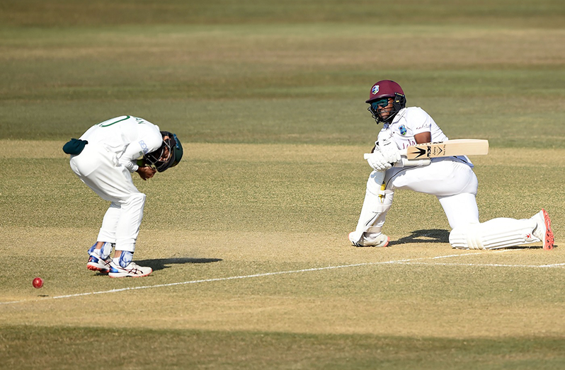 Kraigg Brathwaite sweeps down on one knee © AFP via Getty Images