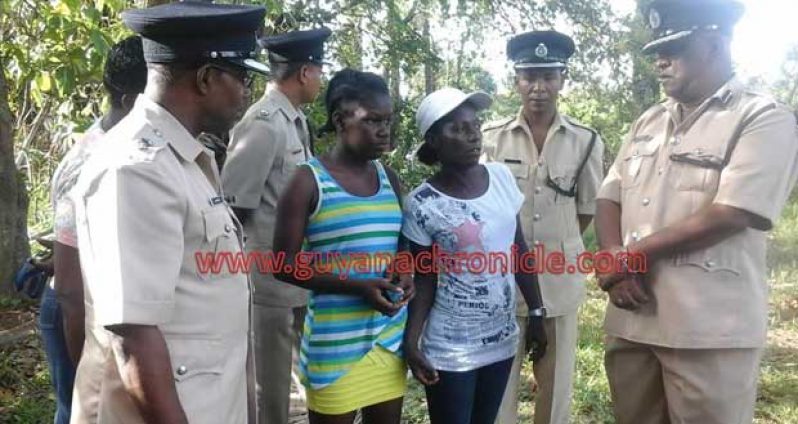 ‘A’ Division Commander, Clifton Hicken at extreme left and Assistant Commissioner Balram Persaud meets with the relatives of the 15 year old