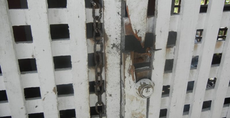 The door with the chain that Singh damaged to get to the children.