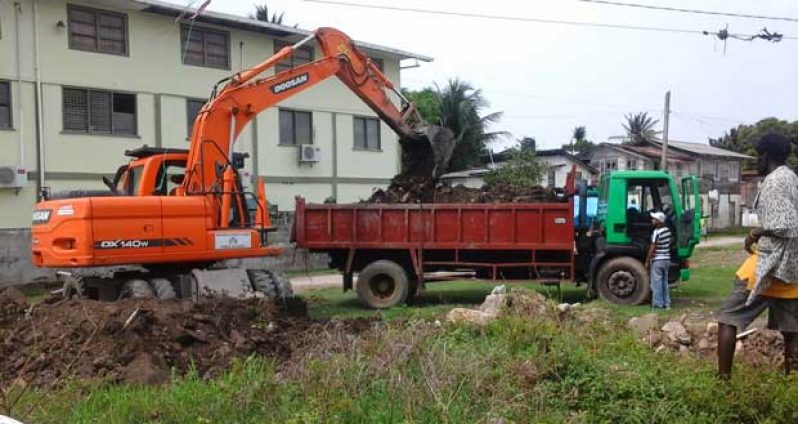 The Ministry of Public Works’ machinery loading dirt into the back of a truck for dumping