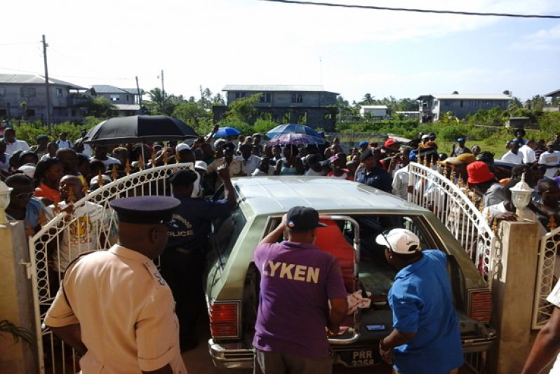 Residents of the area gathered at the scene, anxious to get a glimpse of the dead bandit