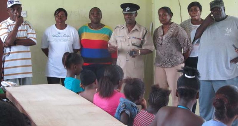 Commander Hicken and the team of police and community leaders address the children
