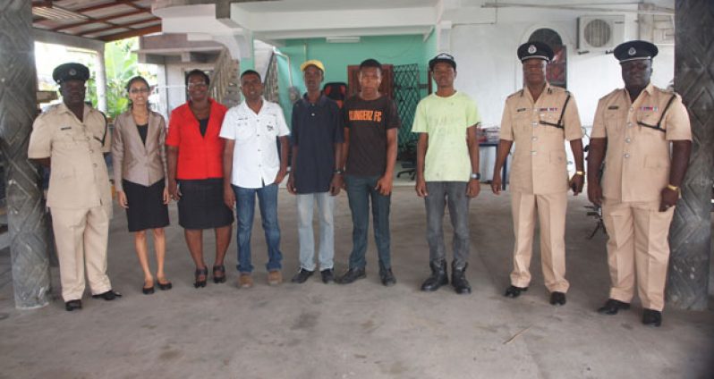 The three young apprentices with the police, their new boss and office staff