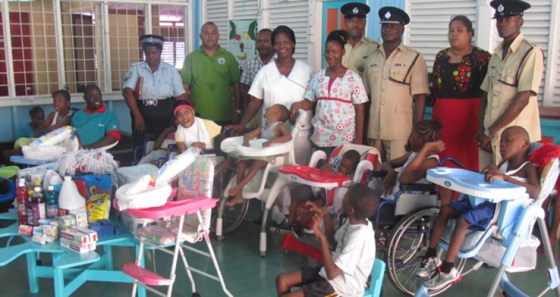 Station Management members, police and children from the centre with the items donated
