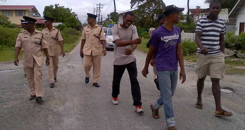 Residents of Agricola accompany Commander Hicken and other senior ranks to the Community Centre Ground on Monday (Photos by Leroy Smith)