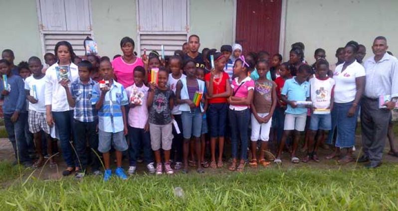 The students pose with their headteacher, police and CPG members for a photo opportunity after the donation was made