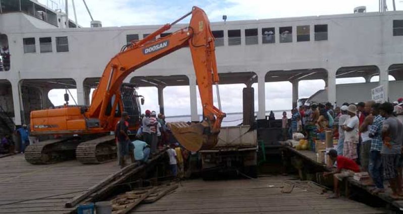 The Public Works excavator moving the stone to the back of the truck to make the front of the truck lighter