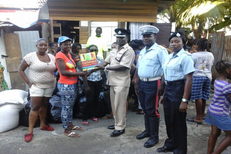 Deputy Commander Moore handing over supplies to a community leader of Tiger Bay