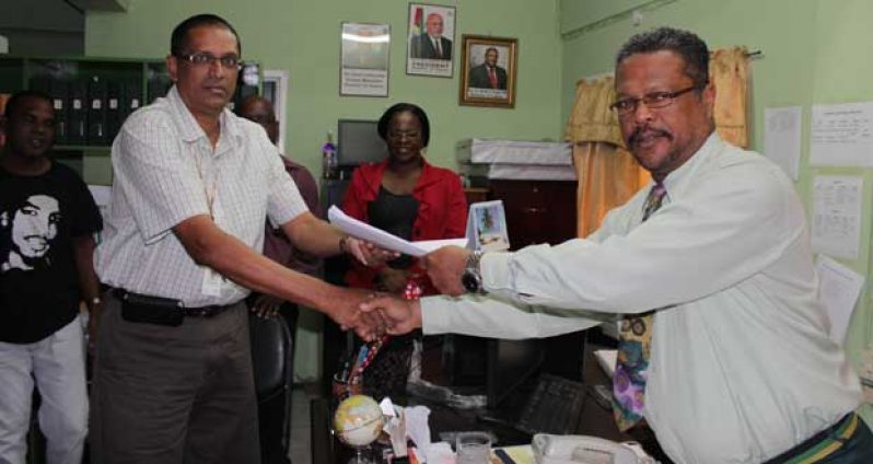 Sterling Products Ltd CEO, Mr. Ramsay Ali and Chief Labour Officer Mr Charles Ogle at the signing of the agreement between the company and CCWU