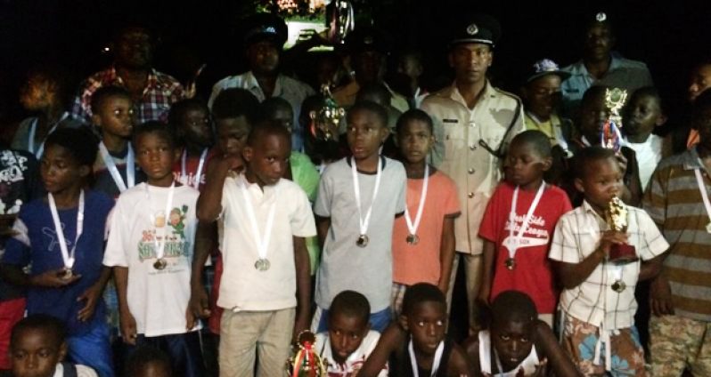Commander Brutus poses with the youths of Linden after the fun day last Sunday
