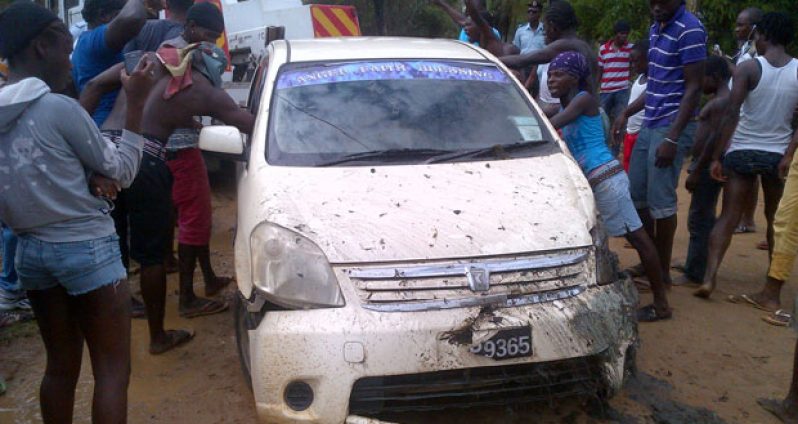 The damaged car being placed on a crash truck