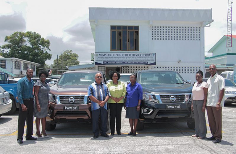 Minister of Public Health, Volda Lawrence, stands with other health officials and representatives of Global Fund on Friday at the Ministry of Public Health