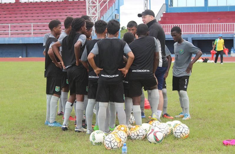 Technical Director Ian Greenwood passes out instructions to the players at their recent training session.