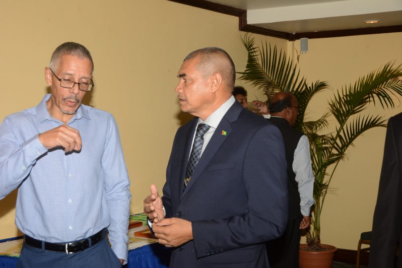 Former Minister of Business, Dominic Gaskin (left) and his successor, Minister Haimraj Rajkumar, in conversation (Adrian Narine photo)