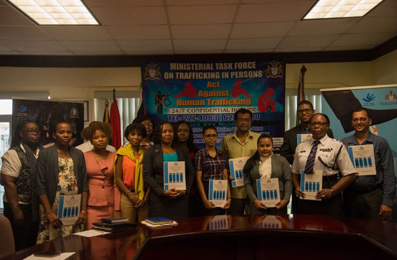 Minister of Public Security, Khemraj Ramjattan (back row, second from right) with representatives from the agencies in the Ministerial Task Force on Trafficking in Persons displaying copies of the 2019 –2020 National Plan of Action for the Prevention and Response to Trafficking in Persons