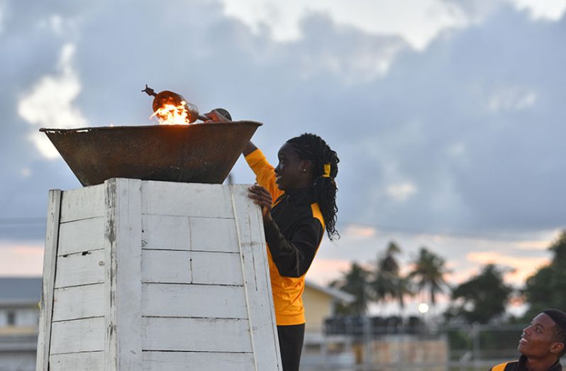 ‘Nationals’ U-16 200M and 400M record-holder and South American Youth Games gold medallist, Deshanna Skeete, lights the symbolic games torch. (Samuel Maughn photos)