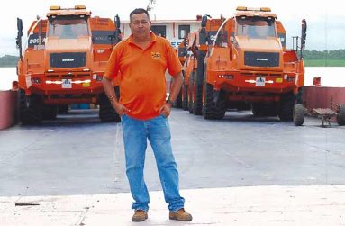 Heralall Ramcharan poses in front of his trucks