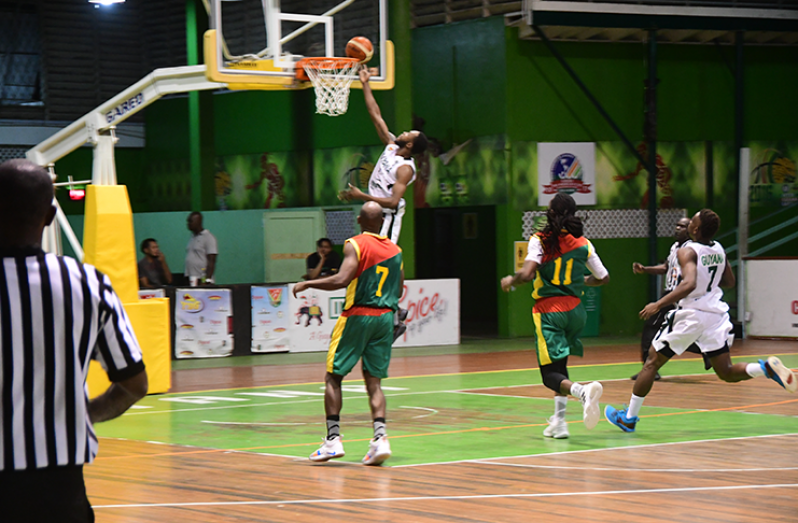 Guyana’s Travis Belgrave scores at the rim during his team’s 90-73 points win over Grenada in their Three-game Goodwill Series at Cliff Anderson Sports Hall. (Adrian Narine photo) 