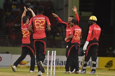 The Trinbago Knight Riders celebrating the dismissal of another Warriors wicket.
