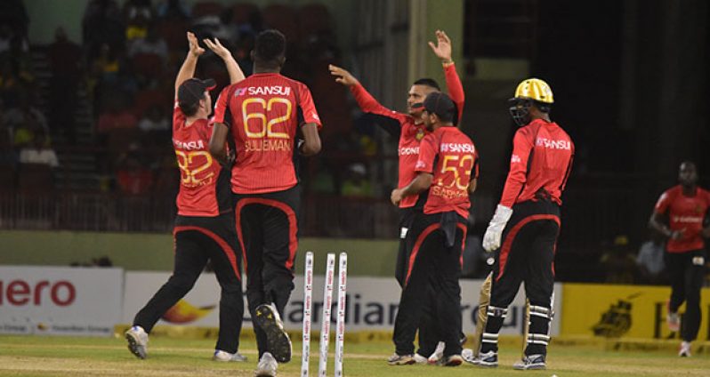 The Trinbago Knight Riders celebrating the dismissal of another Warriors wicket.