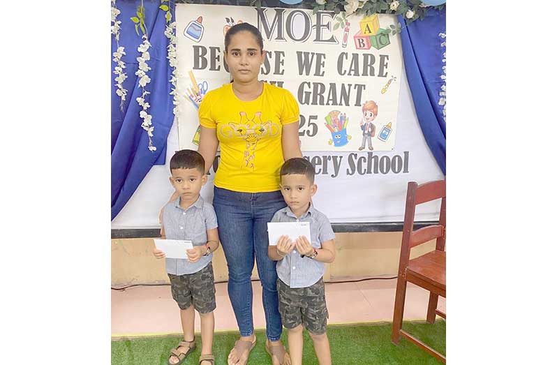 A mother of twin boys uplifting their cash grant